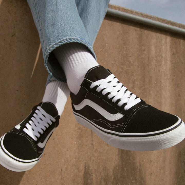 Classic Black Vans Old Skools with White Socks and Blue Jeans