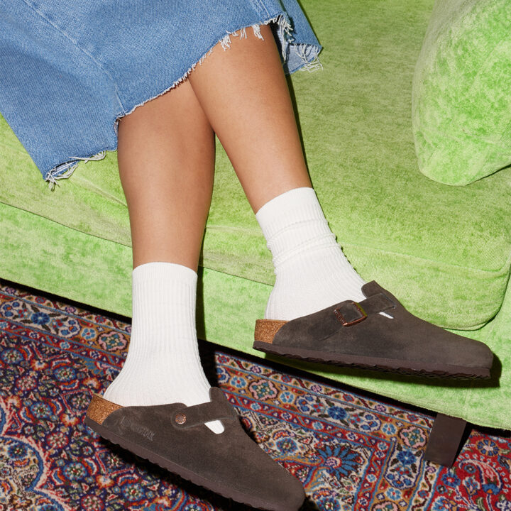Person wearing brown Birkenstock Bostons.