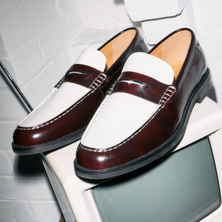 A pair of burgundy and white loafers.