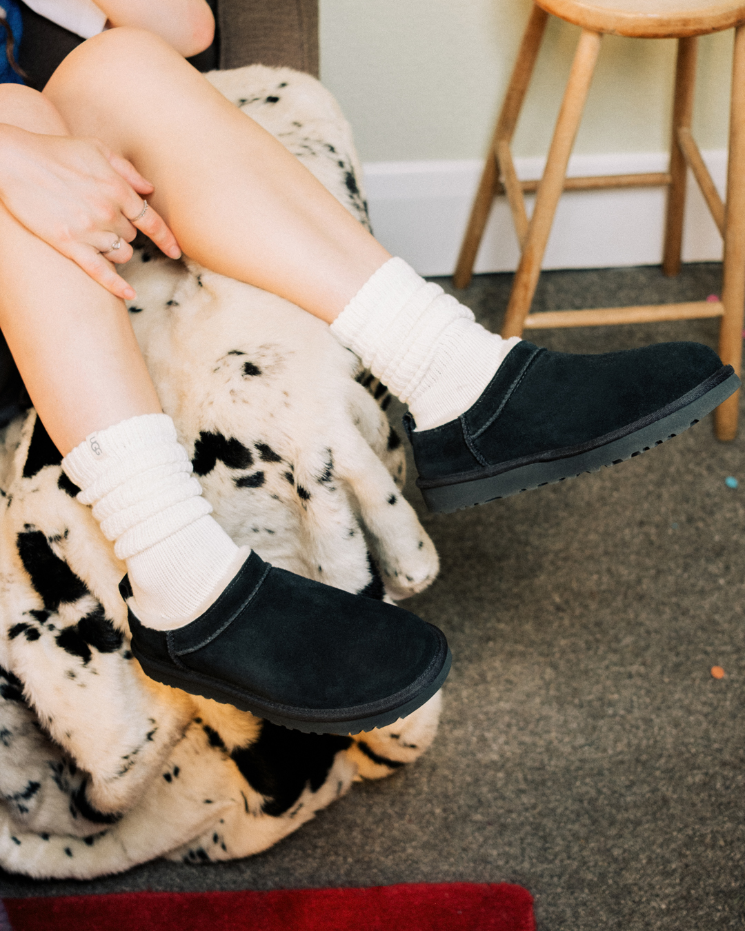 Person wearing black UGG Classic Micros.