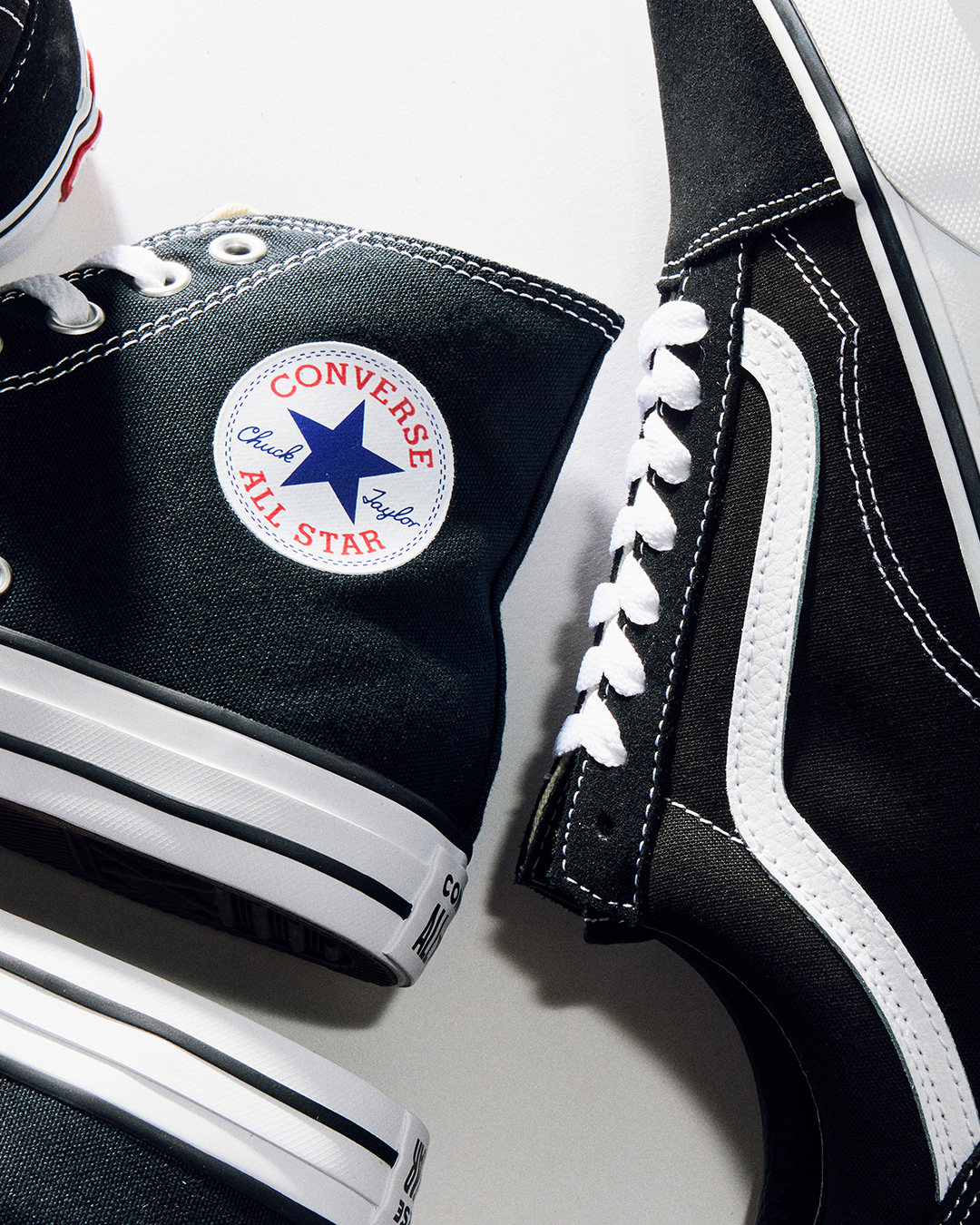 A black Converse All Star Hi and black Vans Old Skool.