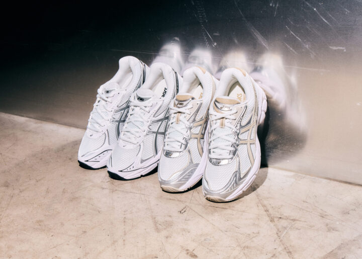 Two pairs of ASICS GT-2160 trainers in white, one with silver details and one with beige details.