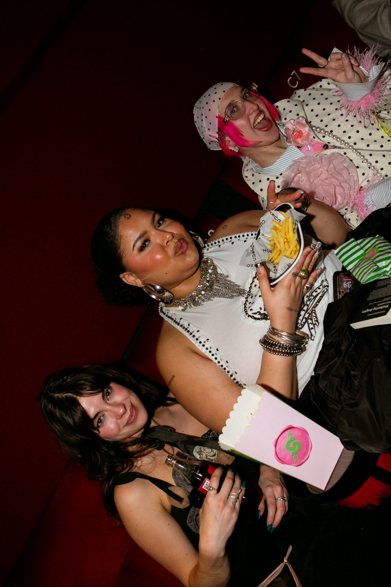 Three guests at the screening with food and schuh branded popcorn.