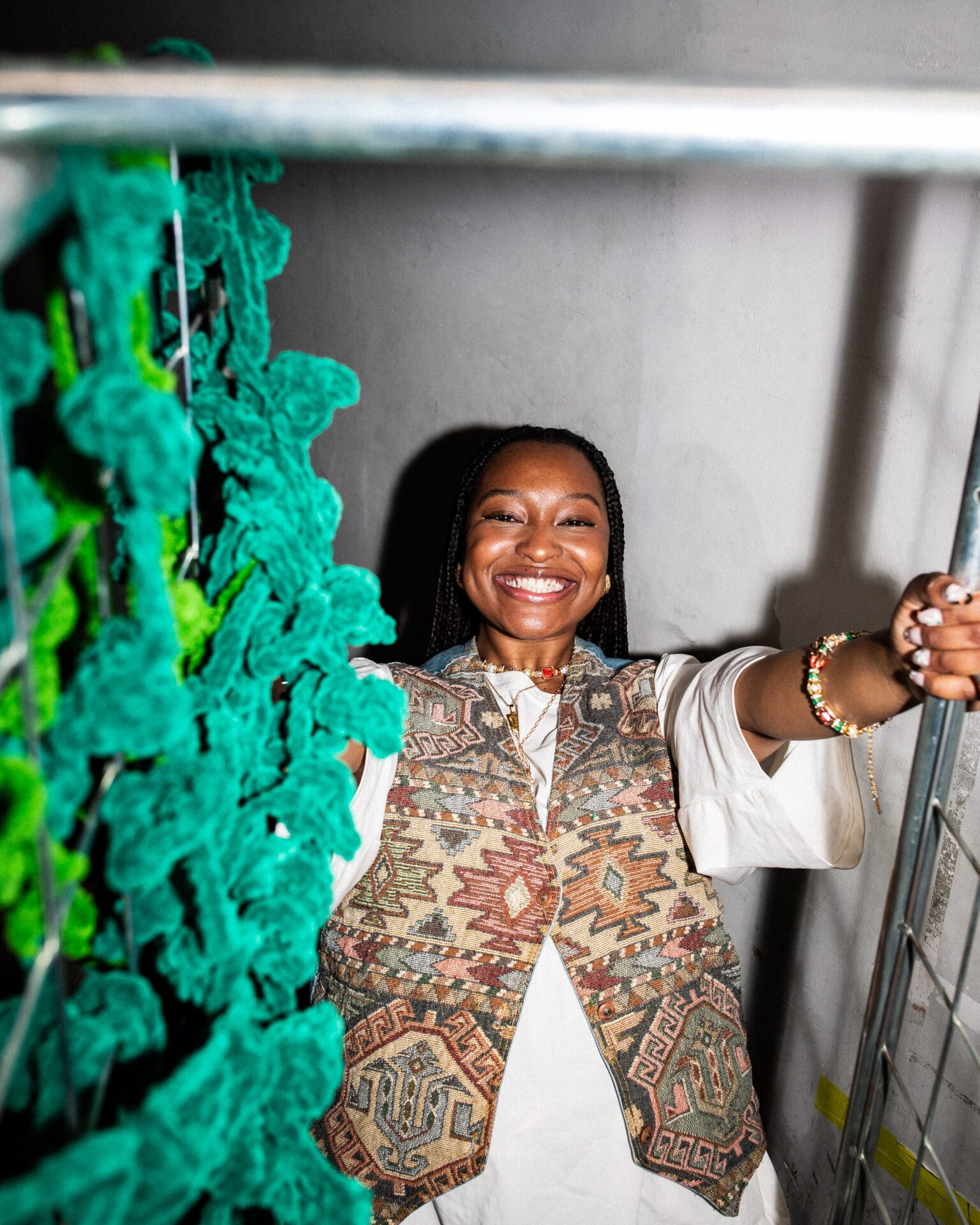 Brandina wearing a white t-shirt and patterned waistcoat.
