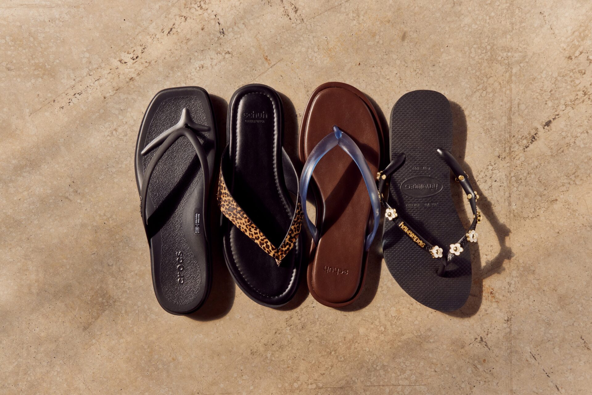 4 flip flops in black and brown colourways.