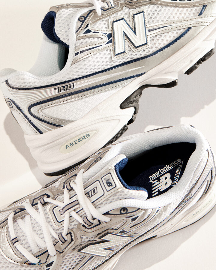 A pair of white & silver New Balance 740s.