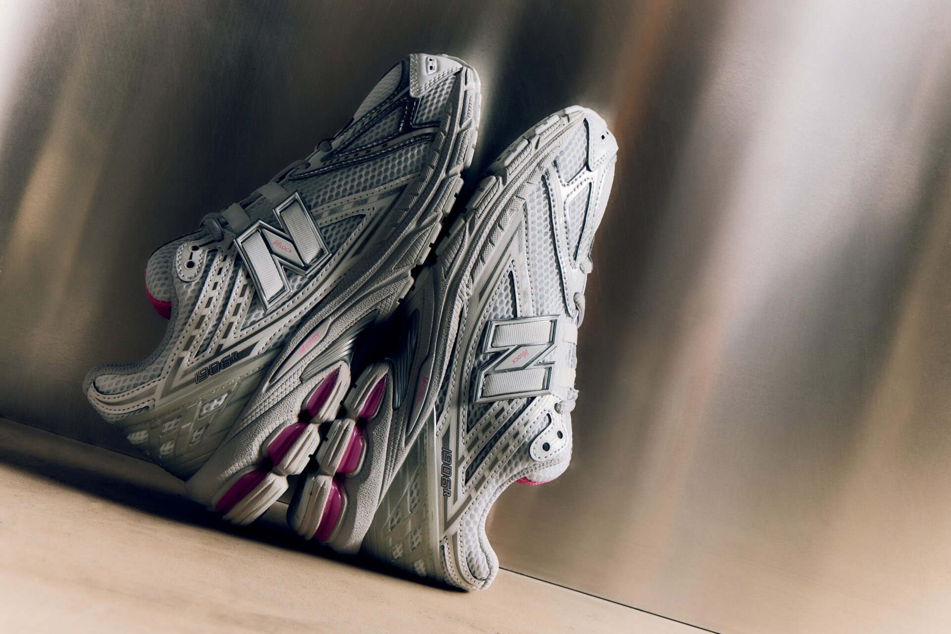 One pair of grey New Balance 1906 with pink detailing